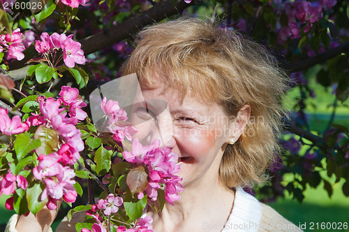 Image of a middle-aged woman in a blossoming magnolias