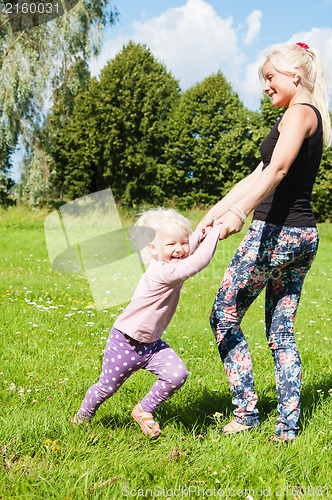 Image of Mum with a daughter play to a glade
