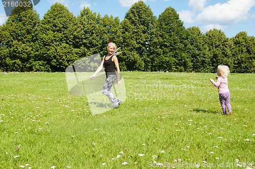 Image of Mum with a daughter play to a glade