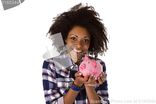 Image of Young african american woman with piggy bank