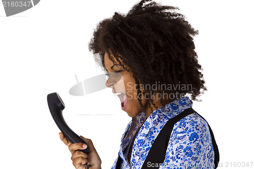 Image of Angry african american woman with handset