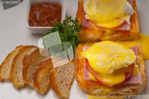 Image of eggs benedict on bread with tomato and ham