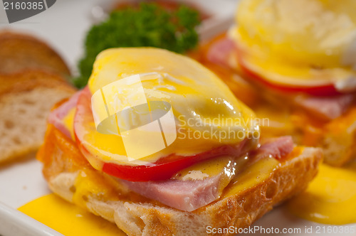 Image of eggs benedict on bread with tomato and ham