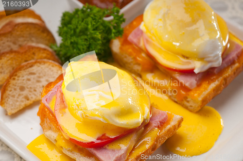 Image of eggs benedict on bread with tomato and ham