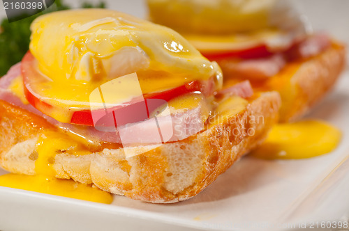 Image of eggs benedict on bread with tomato and ham