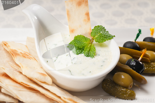 Image of Greek Tzatziki yogurt dip and pita bread