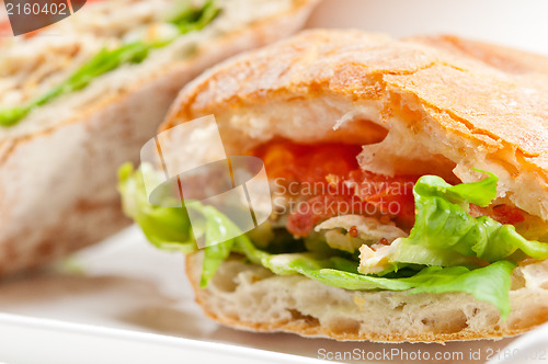 Image of ciabatta panini sandwich with chicken and tomato