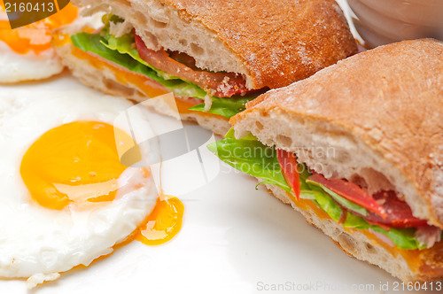 Image of ciabatta panini sandwich eggs tomato lettuce