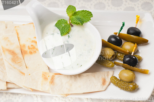 Image of Greek Tzatziki yogurt dip and pita bread