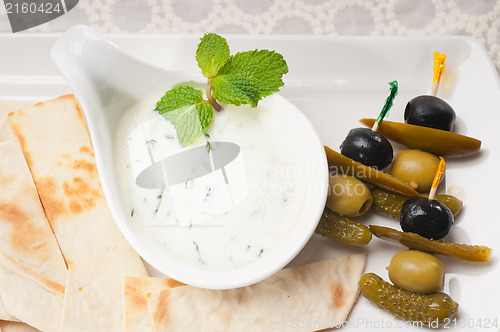 Image of Greek Tzatziki yogurt dip and pita bread