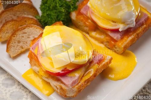 Image of eggs benedict on bread with tomato and ham