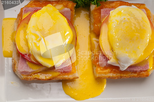 Image of eggs benedict on bread with tomato and ham