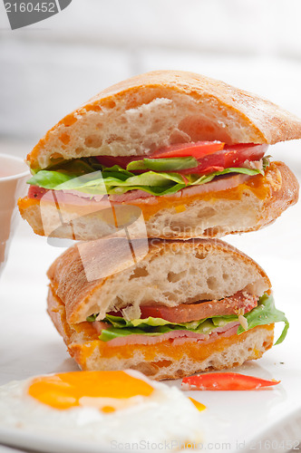 Image of ciabatta panini sandwich eggs tomato lettuce