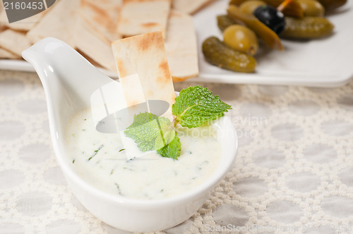 Image of Greek Tzatziki yogurt dip and pita bread