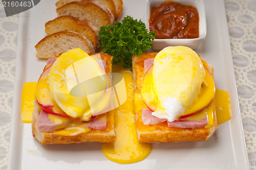 Image of eggs benedict on bread with tomato and ham