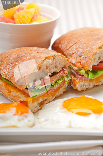 Image of ciabatta panini sandwich eggs tomato lettuce