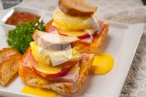 Image of eggs benedict on bread with tomato and ham