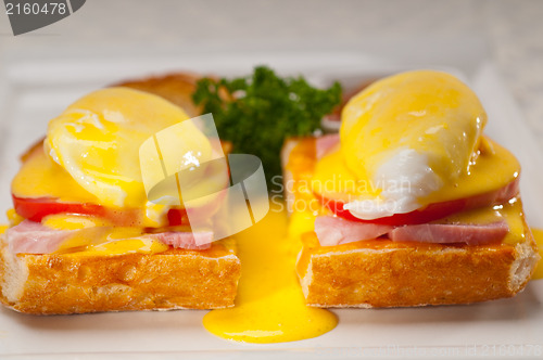 Image of eggs benedict on bread with tomato and ham