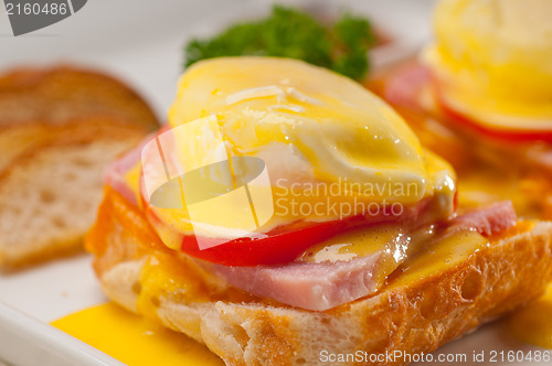 Image of eggs benedict on bread with tomato and ham