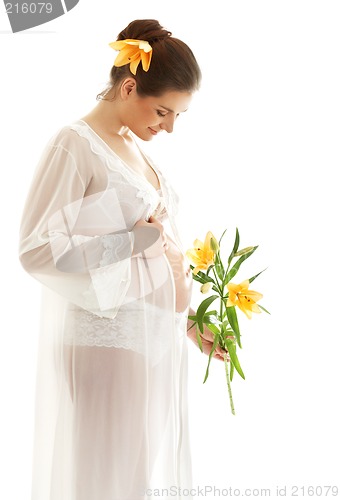 Image of beautiful pregnant woman with yellow lily