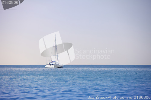 Image of White sailing catamaran on calm sea