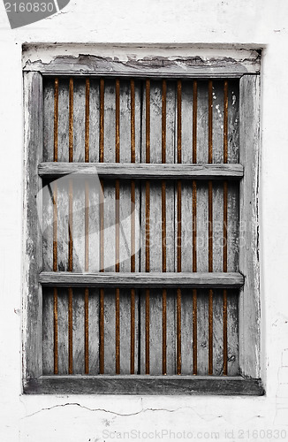 Image of Old wooden window with rusty grate