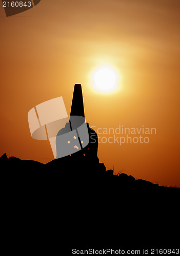 Image of Decorative Buddhist stupa. Silhouette at sunset.
