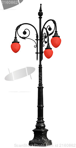 Image of Vintage iron lamppost with red light isolated on white