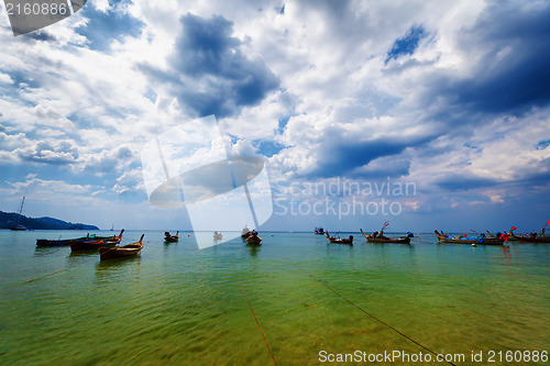 Image of Thai traditional wooden boats in the lagoon