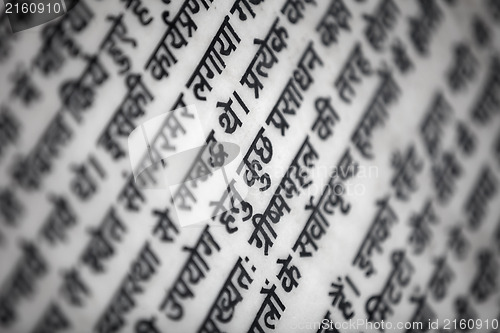 Image of Hindi religious text on white marple wall