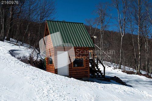 Image of log cabin in snow