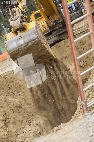 Image of Excavator Tractor Digging A Trench