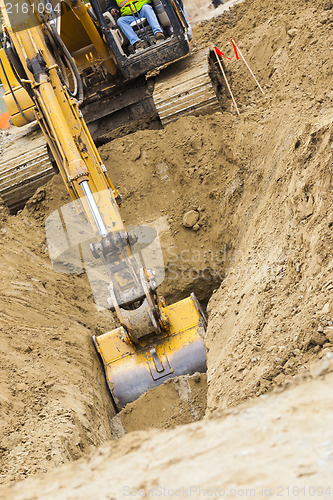 Image of Excavator Tractor Digging A Trench