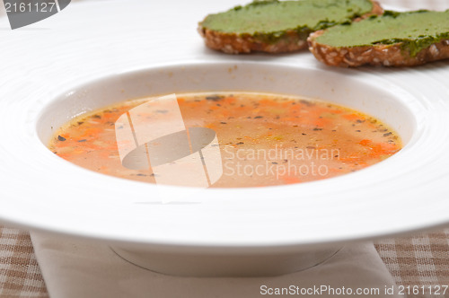 Image of Italian minestrone soup with pesto crostini on side