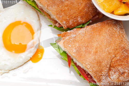 Image of ciabatta panini sandwich eggs tomato lettuce