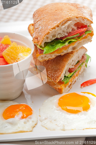 Image of ciabatta panini sandwich eggs tomato lettuce