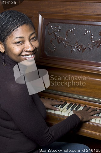 Image of woman in front of old piano