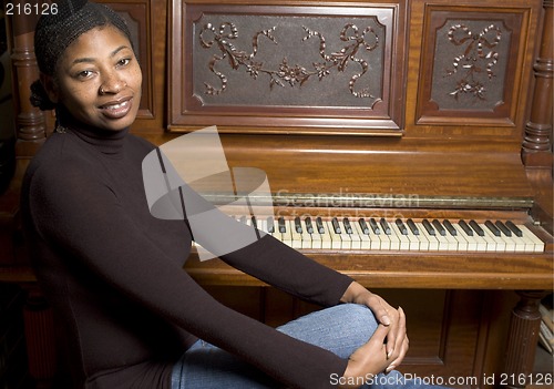 Image of woman in front of old piano