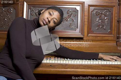 Image of woman in front of old piano