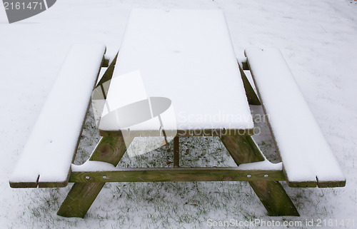 Image of Picknick table covered in snow
