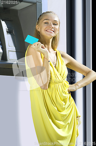 Image of Happy woman with plastic card
