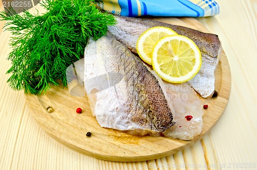 Image of Fillet of codfish on board with napkin