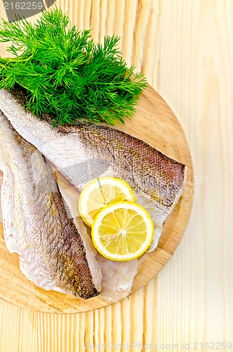 Image of Fillet of codfish on a round plate with lemon