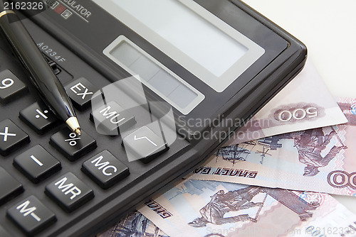 Image of Calculator, money and black pen