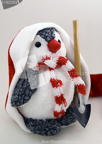 Image of Penguin in cap with spade