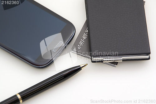Image of Phone, cards, pen. Everything of black colour