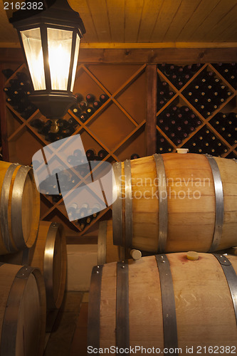 Image of Wine Barrels and Bottles in Cellar