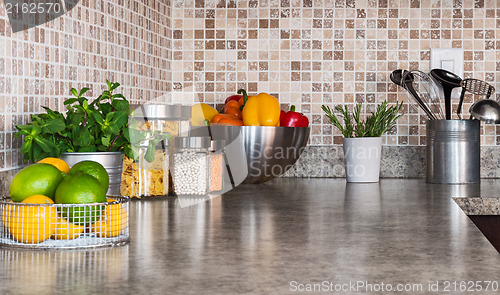 Image of Kitchen countertop with food ingredients and herbs