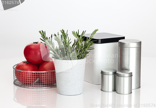 Image of Food storage containers, tomatoes and rosemary