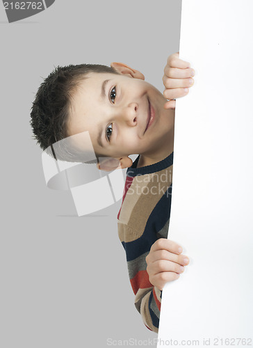 Image of Little boy holding a whiteboard